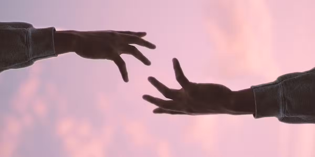 hand reaching out to help other hand