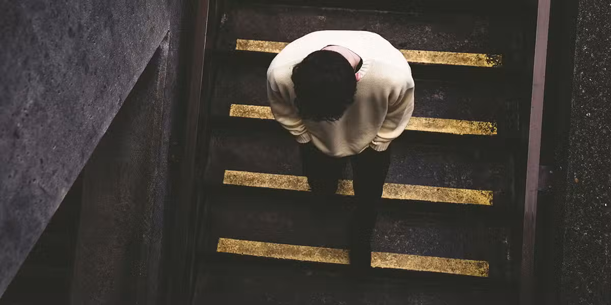person walking down stairs, feeling overwhelmed