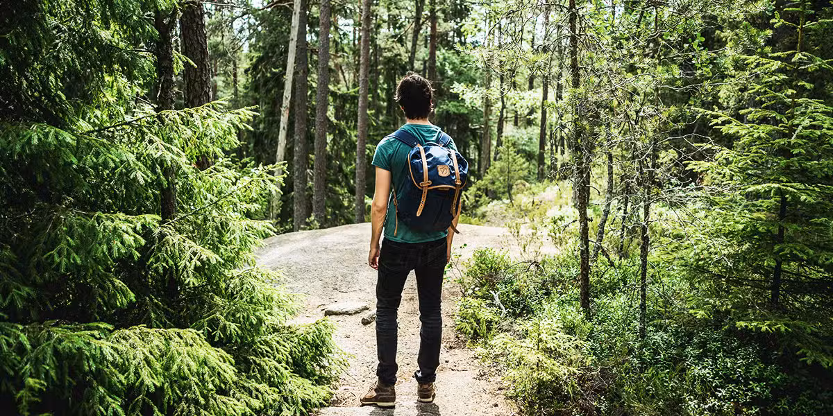 person walking on a trail, following a path.