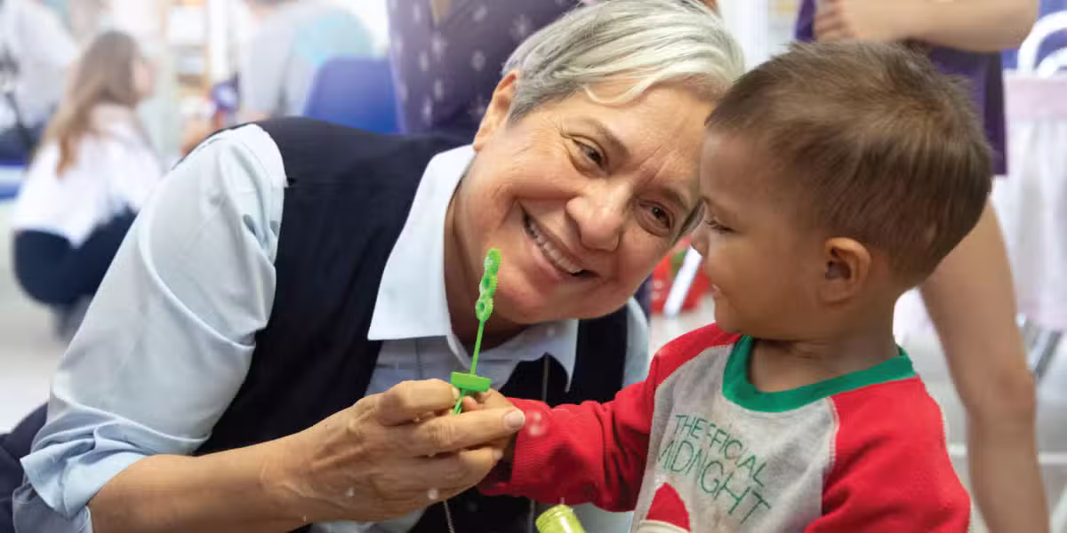 Sister Norma Pimentel plays with a child