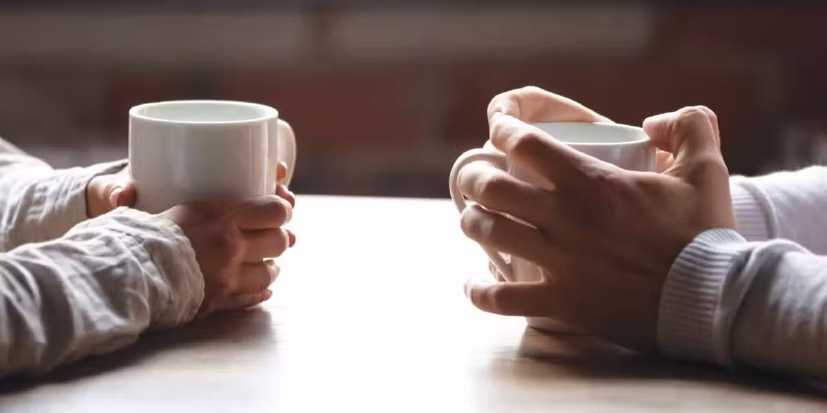 Two people drinking coffee