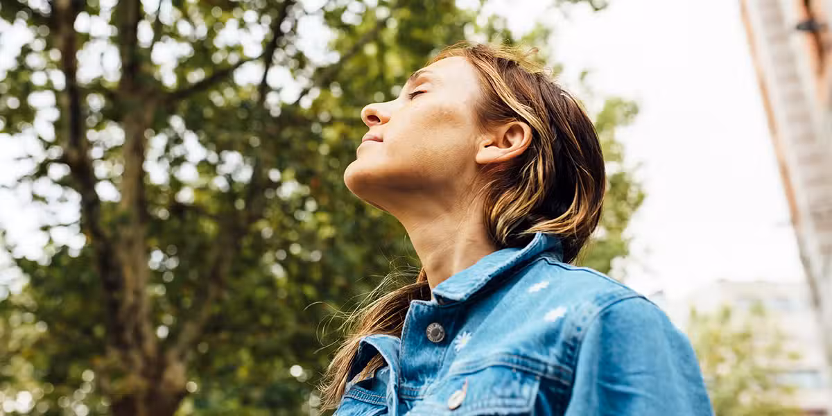 woman taking a deep breath