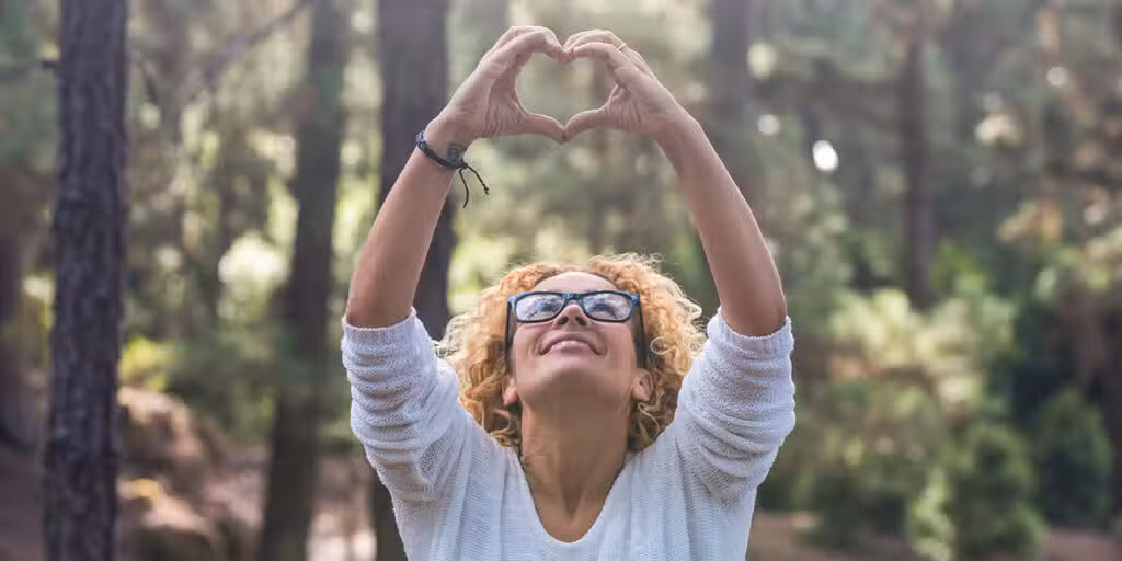 woman forming a heart with her hands