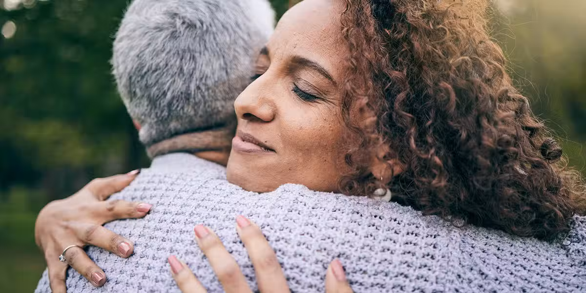 two people in a warm embrace of forgiveness
