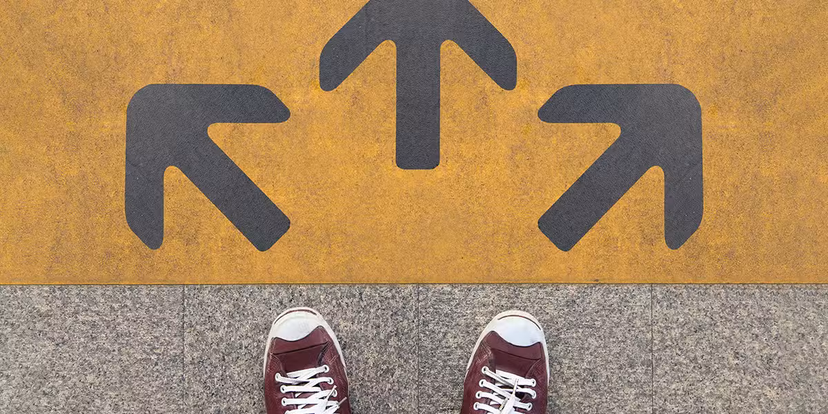 feet in sneakers in front of three arrows