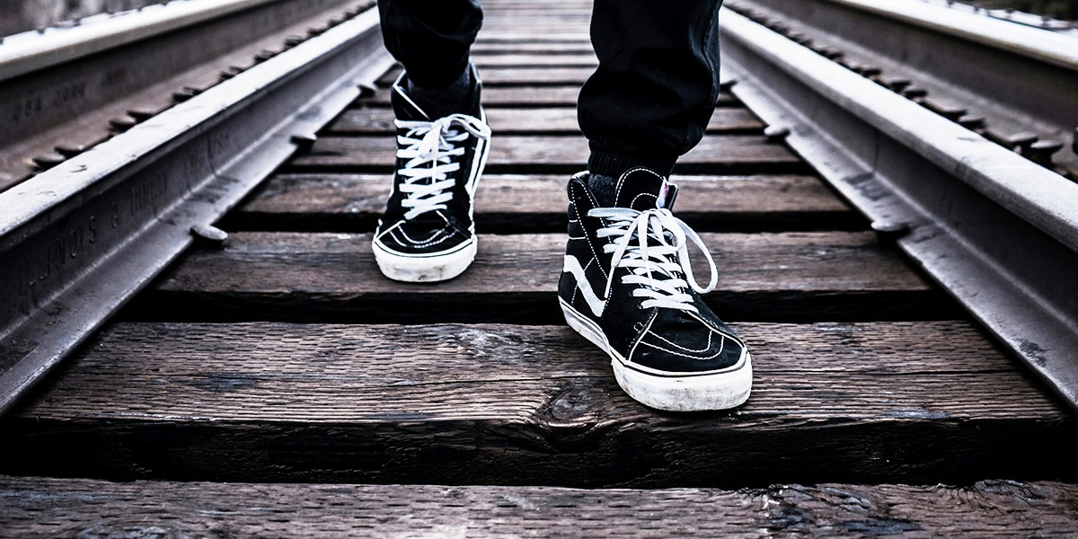 shoes on train tracks taking the next step.