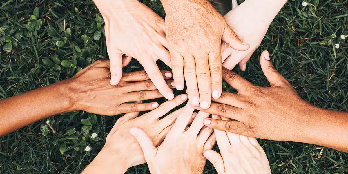 hands stacked on top of each other as a sign of teamwork
