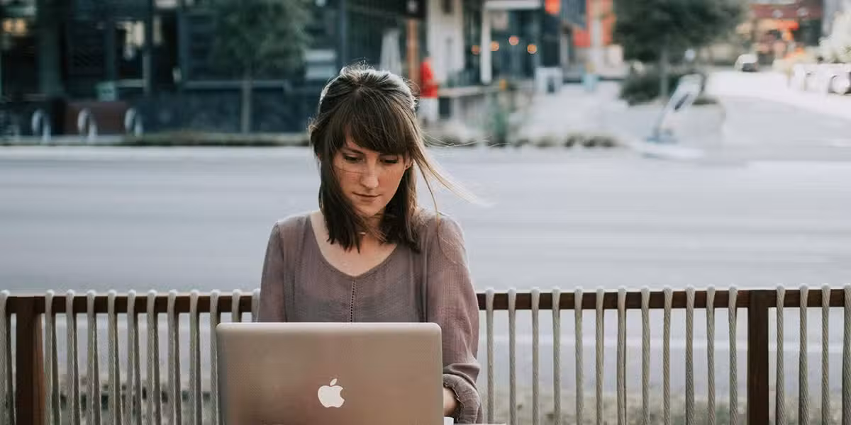 woman reading on her laptop.