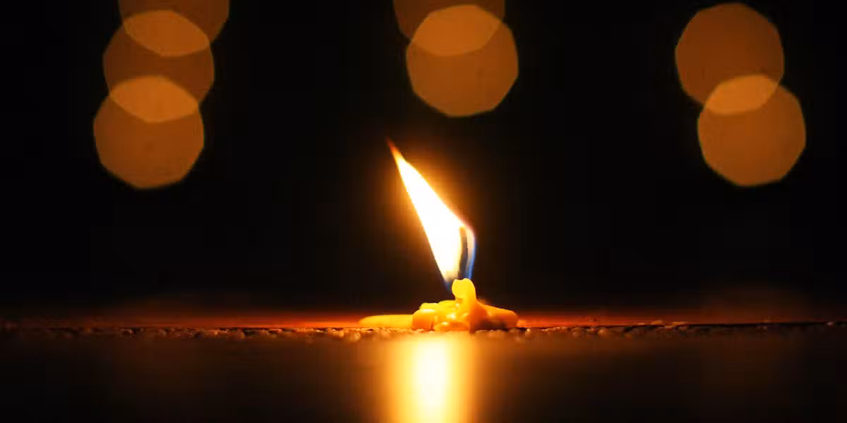 lit candle on table