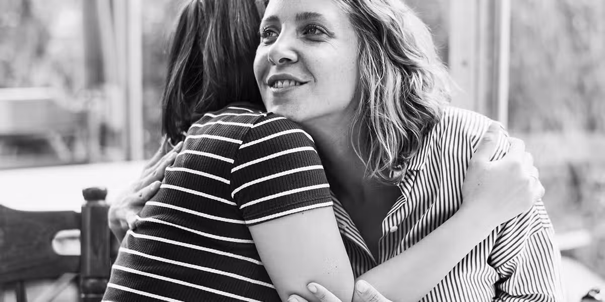 two friends hugging, showing kindness and appreciation for each other.
