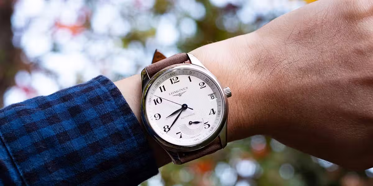 watch on a hand showing the time.