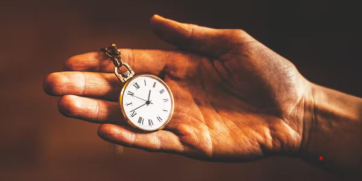 hand holding a watch.
