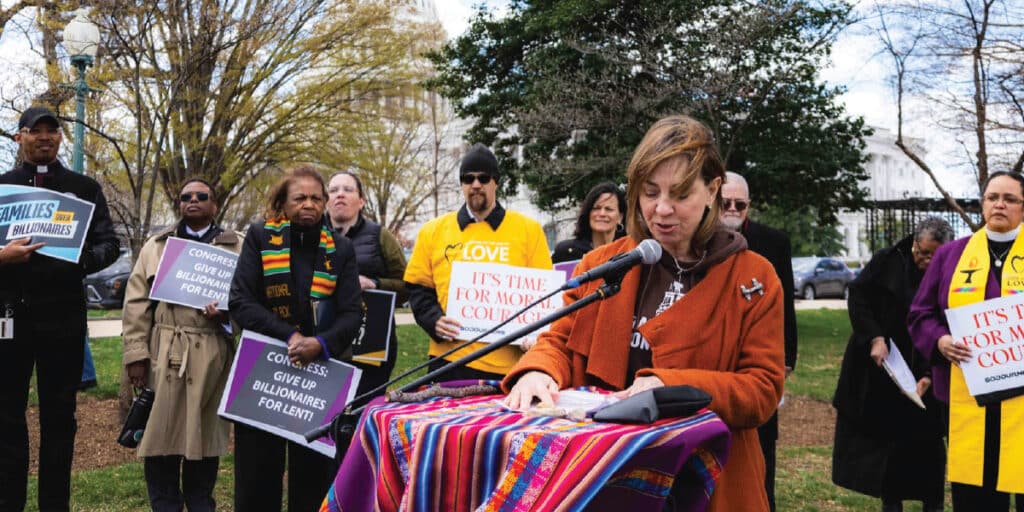Executive Director Michele Dunne speaks in spring 2025 at a Faithful Witness Wednesday multi-faith vigil at the US Capitol, calling for congressional courage in protecting the welfare of all Americans.