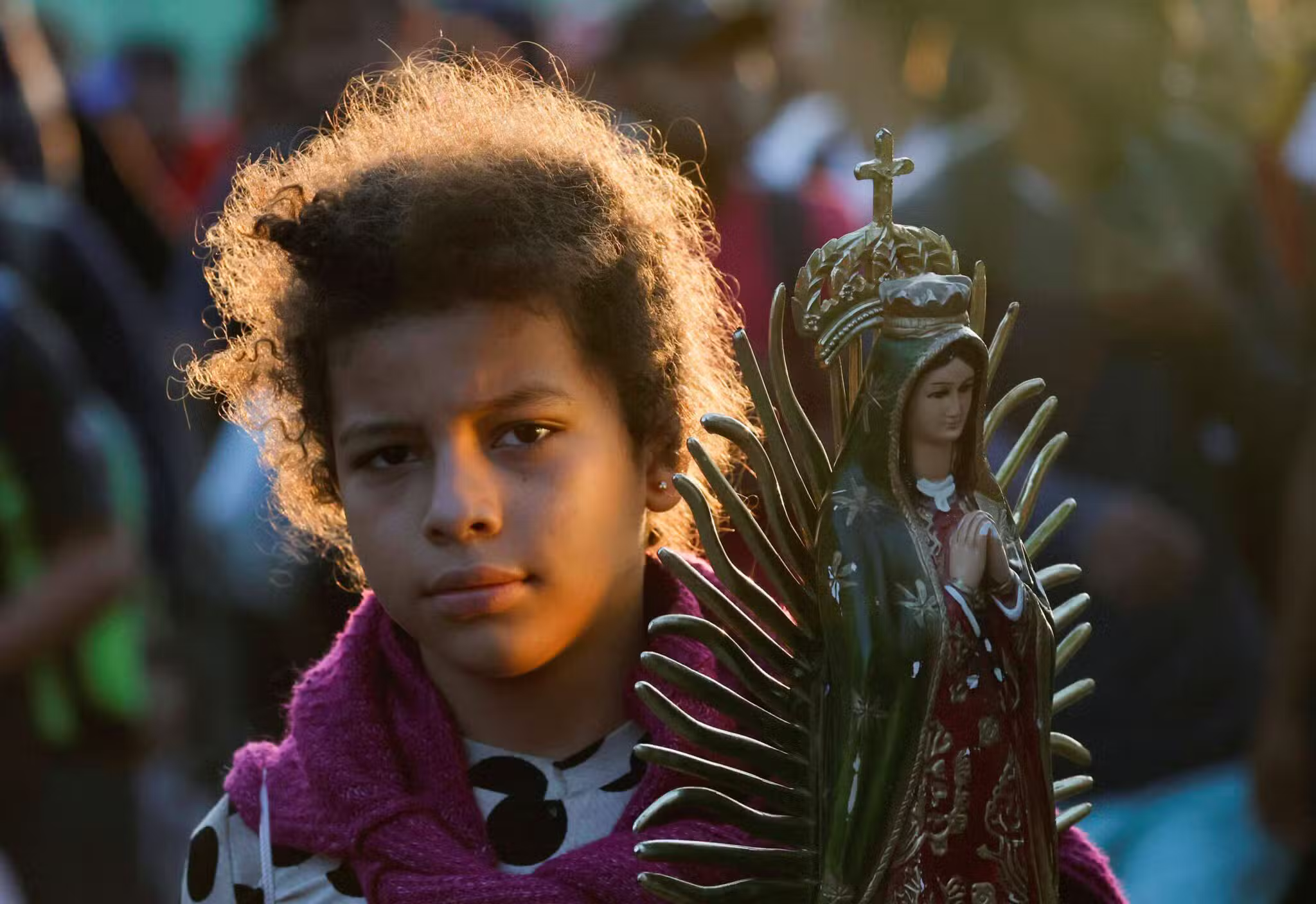A young Venezuelan migrant carries a statue of Our Lady of Guadalupe as she walks with her family in caravan in an attempt to reach the U.S. border, in Tapachula, Mexico, Nov. 5, 2024. (OSV News photo/Daniel Becerril, Reuters)