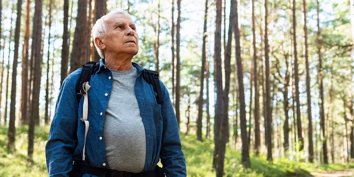 Older person walking outside in a forest