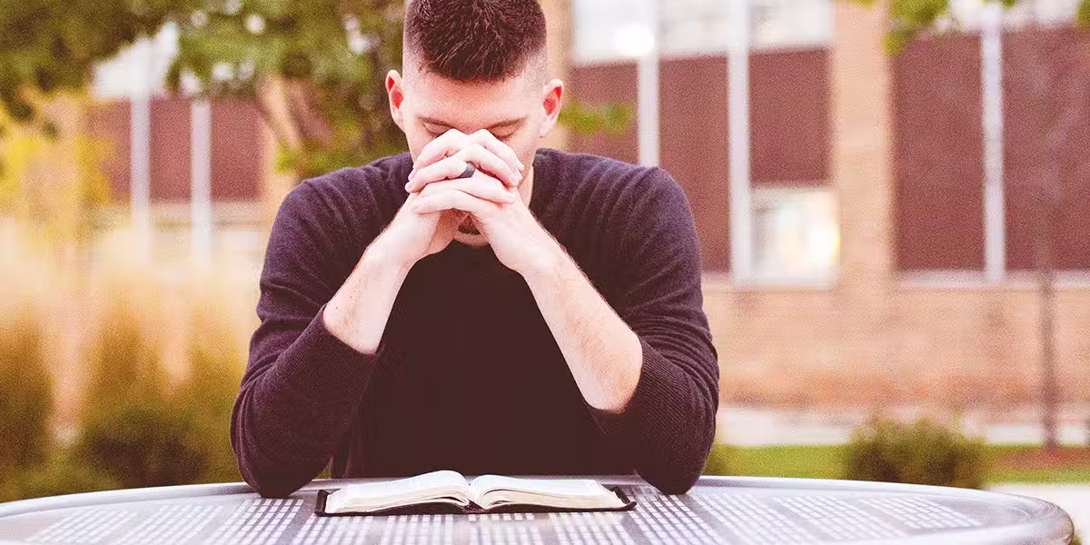 a person praying outdoors