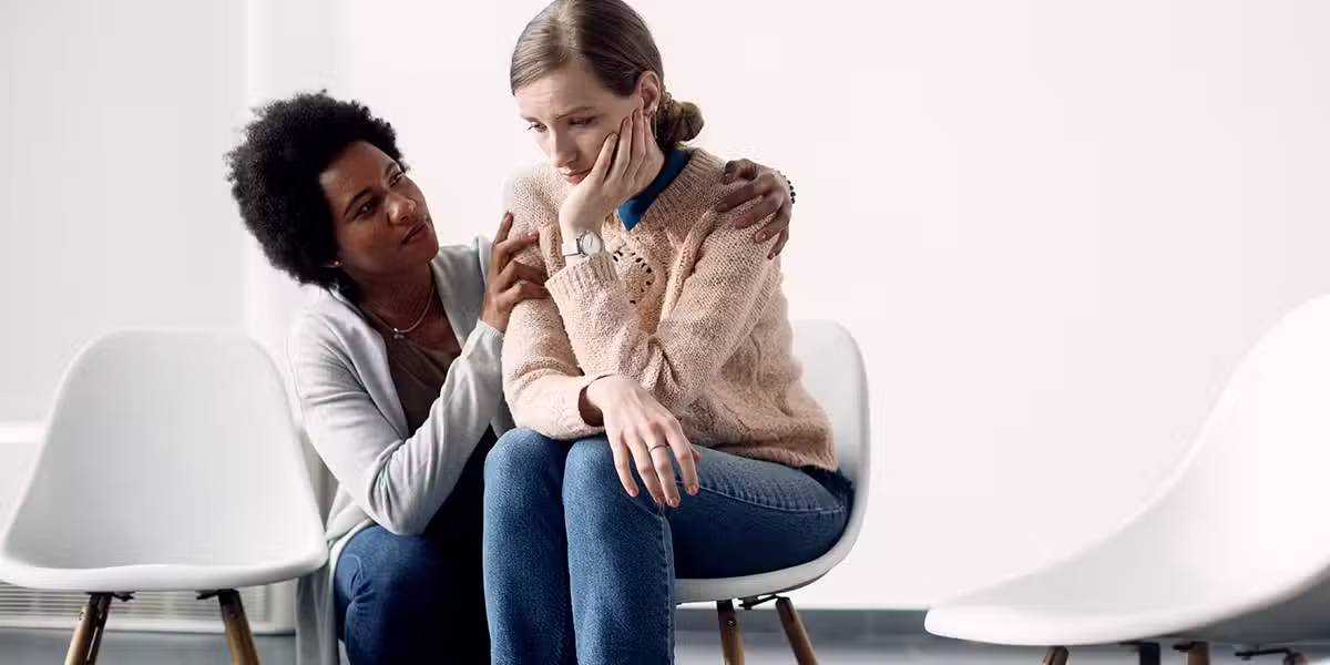 One woman comforting another woman and showing compassion