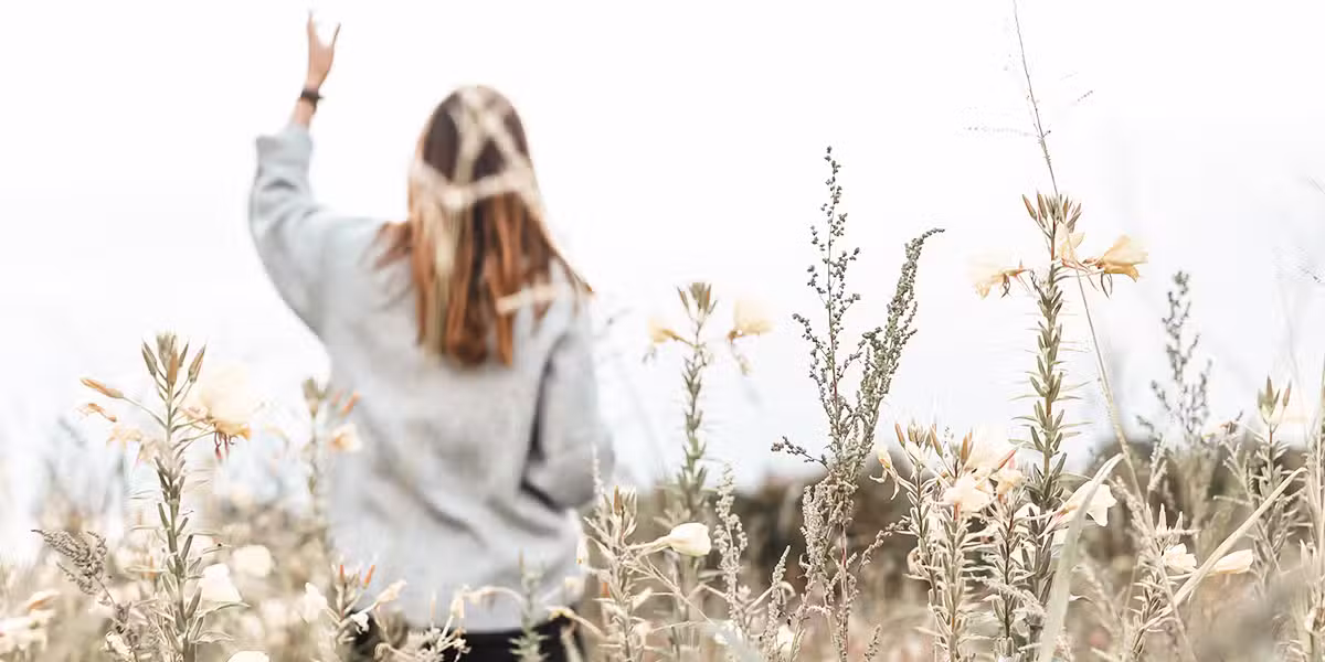 Woman in a field | Photo by Jasmin Ne on Unsplash