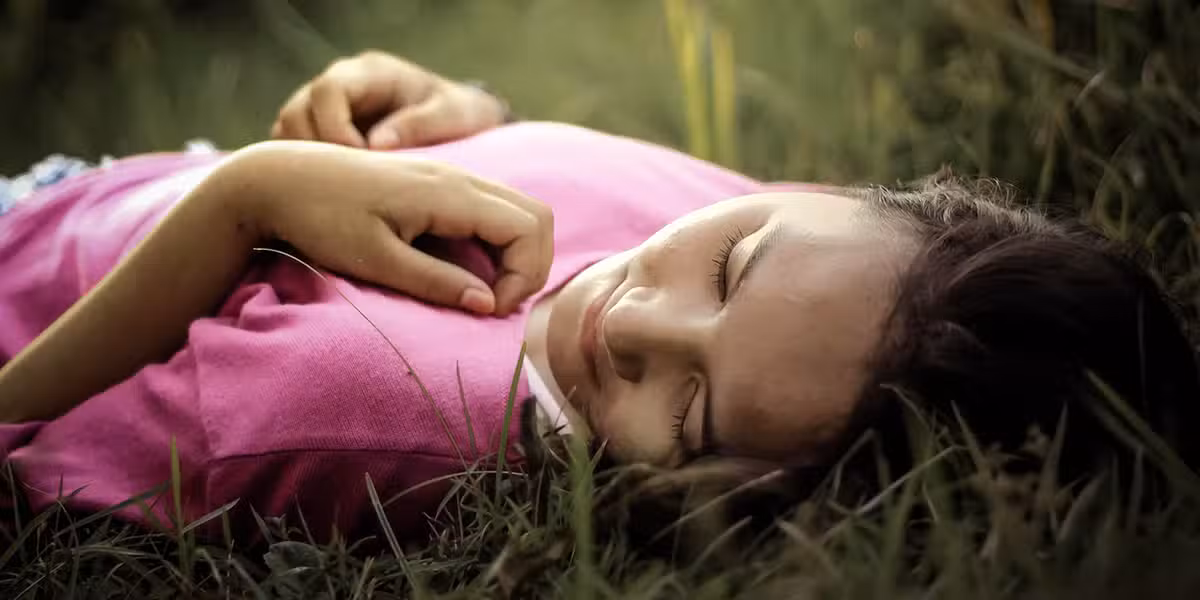 girl lying in the grass