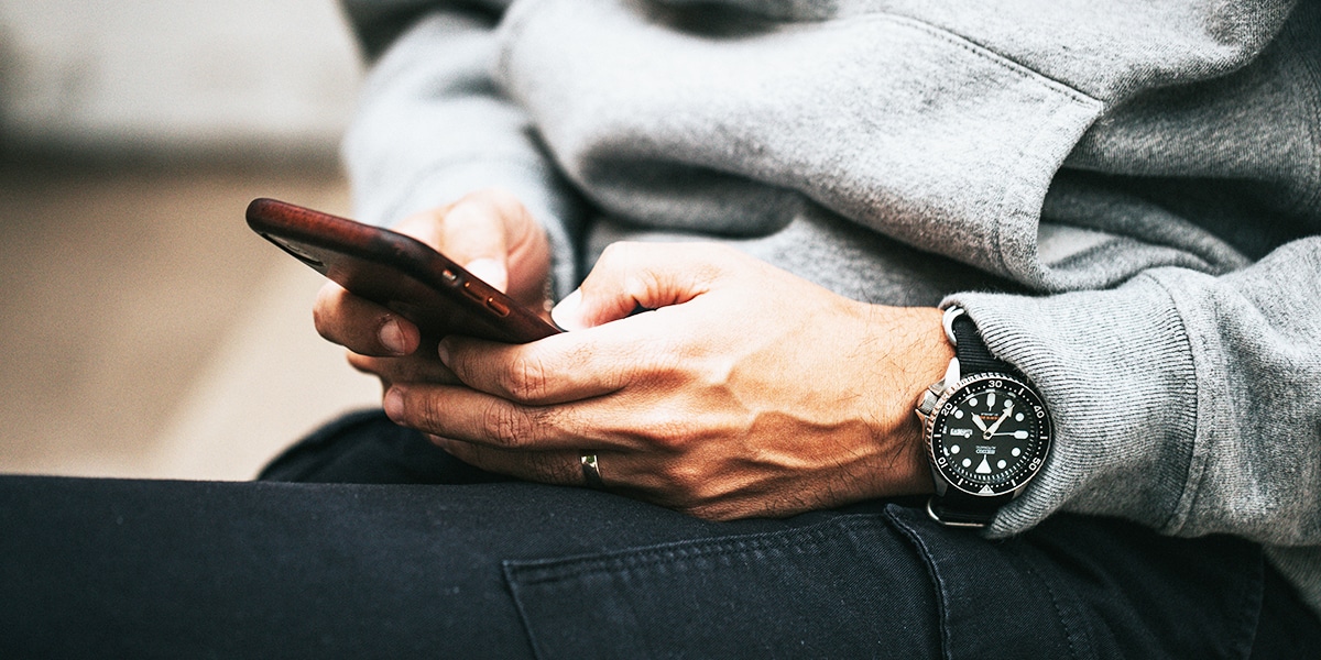 hands texting on a phone