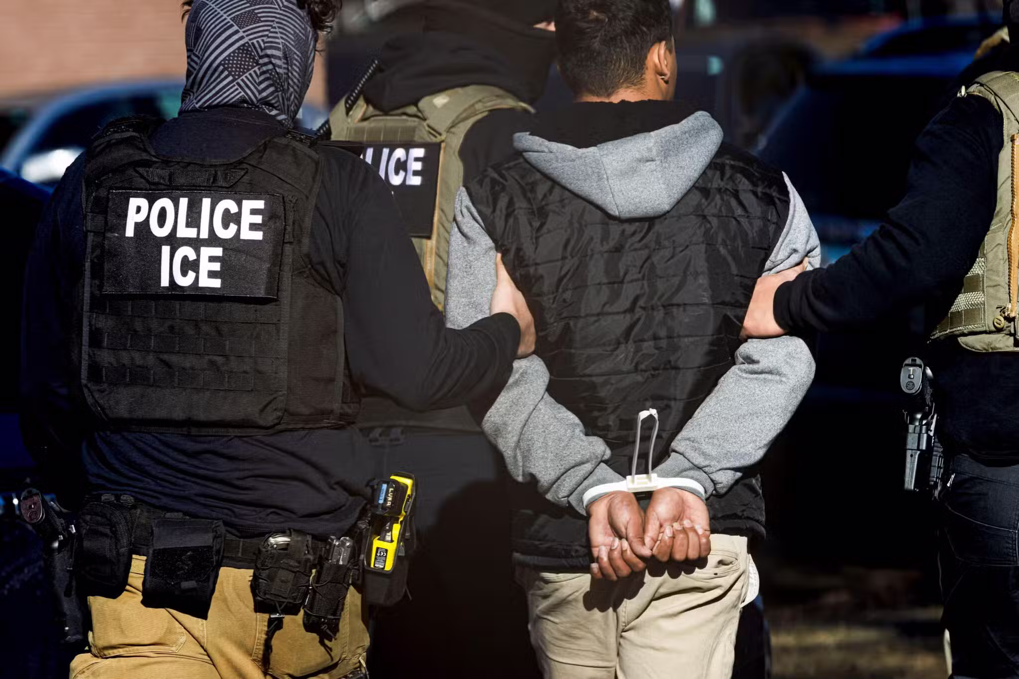 Agents with the Immigration and Customs Enforcement detain a man after conducting a raid at the Cedar Run apartment complex in Denver Feb. 5, 2025.