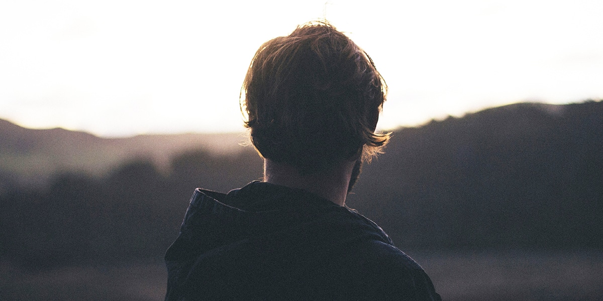 Man standing doing nothing | Photo by Tim Marshall on Unsplash