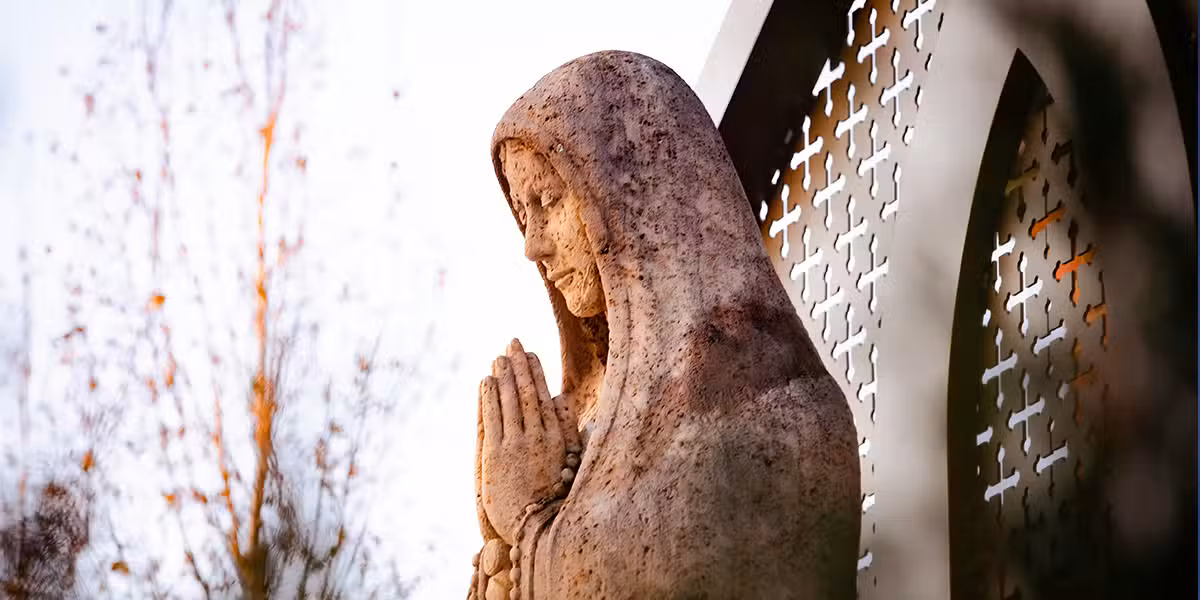 Virgin Mary praying in front of a Church