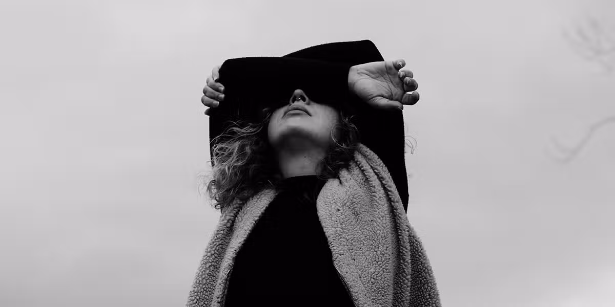 woman being sad and hiding her face behind her arms