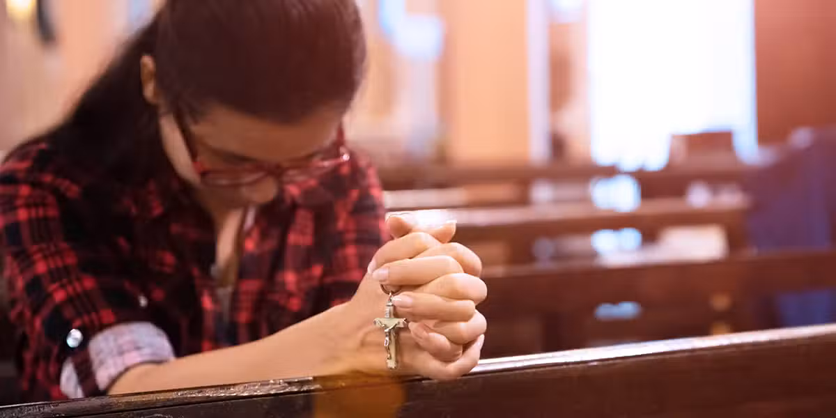 woman praying at a parish.