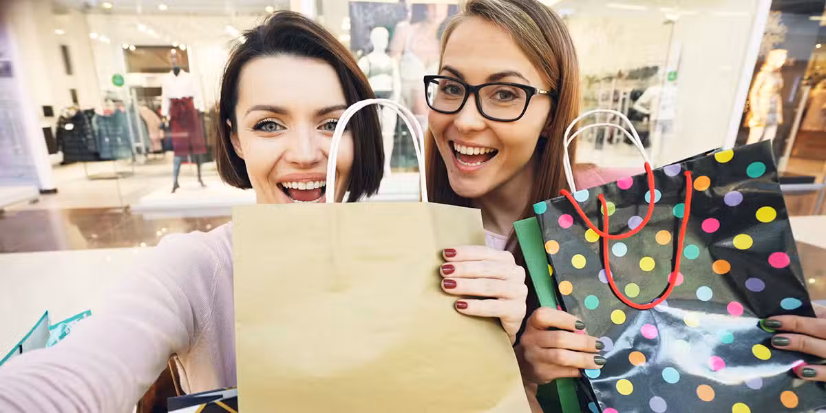 Two women shopping and carrying shopping bags