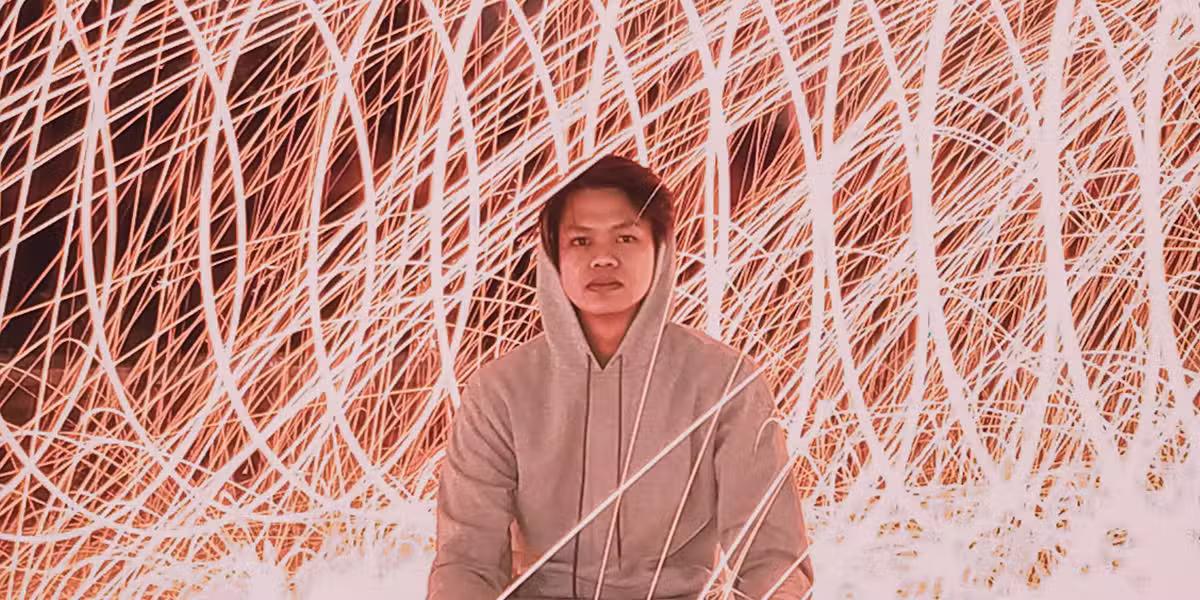 good news in chaos; man sitting still in front of light movement