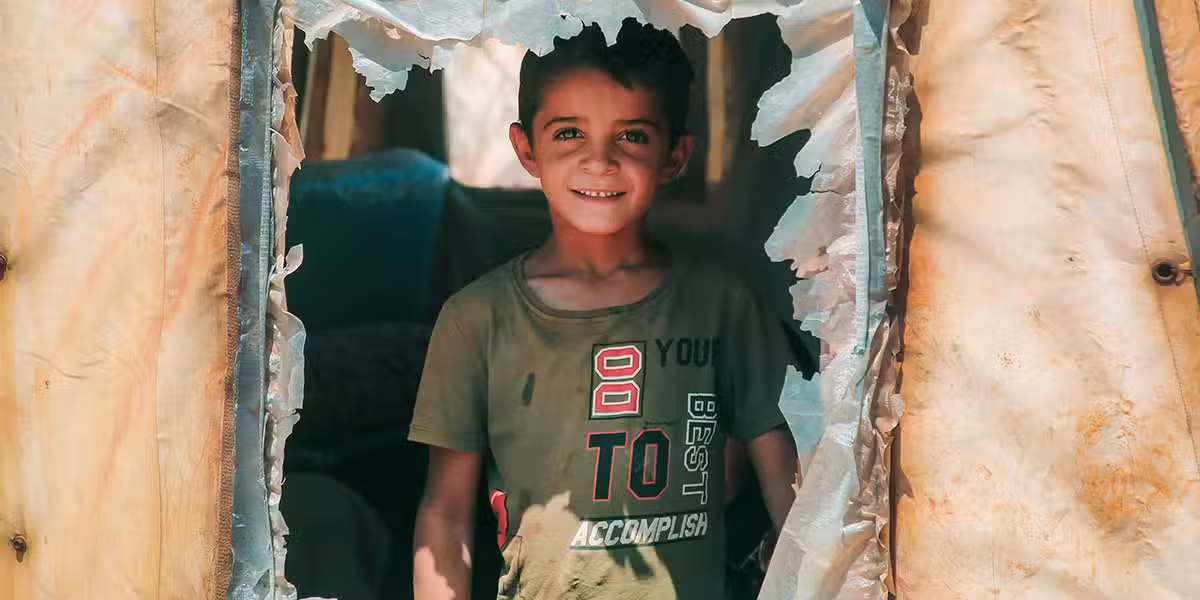 holy refugee; refugee boy in a tent; salad darkish/unsplash