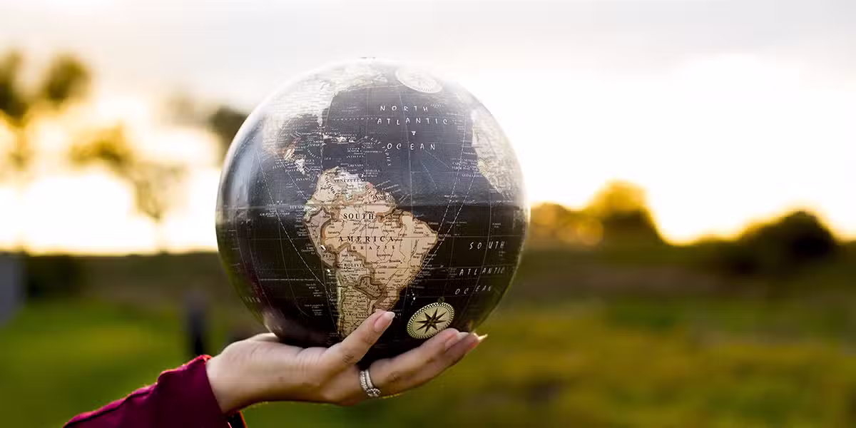 in God's hands, hand holding a globe.