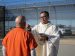 Bishop Alberto Rojas of San Bernardino, Calif., the main celebrant, distributes Communion to a detainee during a Mass on the grounds of the ICE Processing Center near Adelanto, Calif., Dec. 10, 2025. Attendees said the Mass, which took place in the Mojave Desert, was deeply emotional for both the bishops and the roughly 300 detainees present.