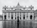 a-woman-walks-by-saint-peters-at-the-vatican