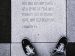black sneakers standing next to a bible verse engraved in stone tile.
