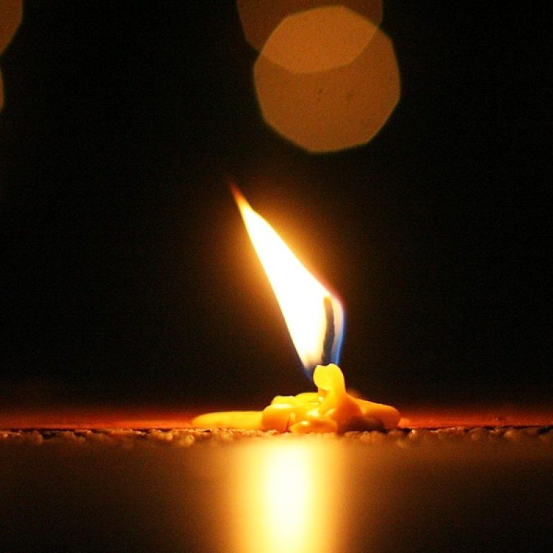 lit candle on table