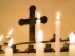 candles burning in front of a cross in a parish