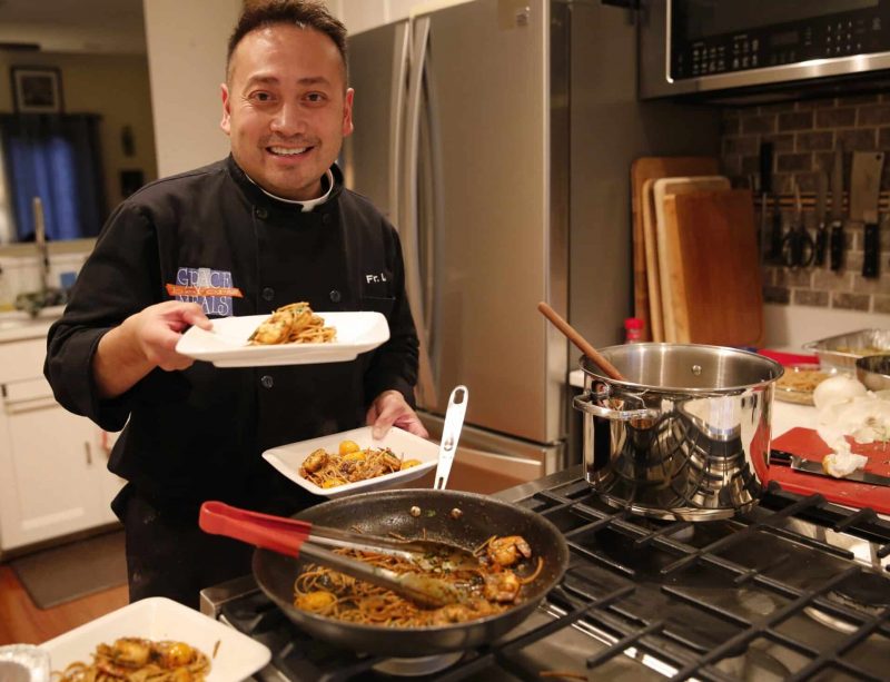 Celebrity chef Father Leo Patalinghug displays a Lenten seafood pasta meal he prepared in his Baltimore kitchen Feb. 24, 2016. During a Nov. 22, 2019, session at the National Catholic Youth Conference in Indianapolis, Father Patalinghug, better known as the "the cooking priest," provided a different kind of recipe, "Five Steps to Become a Teenage Saint," to help youths get to heaven. (CNS photo/Chaz Muth)