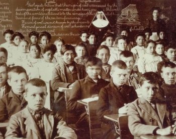 Children sit in a Native American boarding school