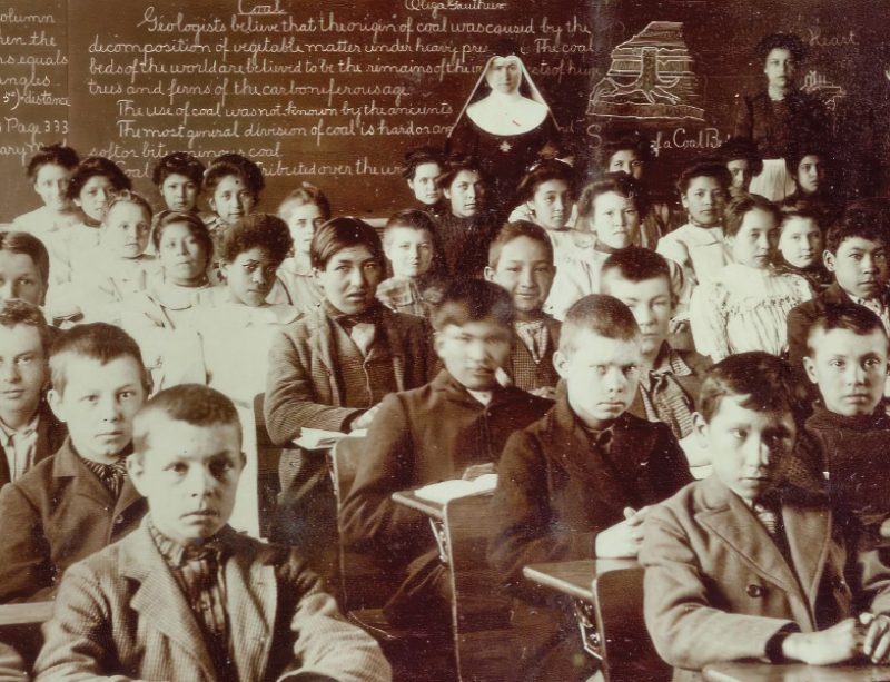 Children sit in a Native American boarding school