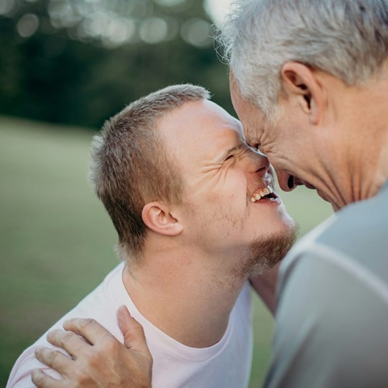 Father enjoying a moment with his son who has Downs Syndrome.