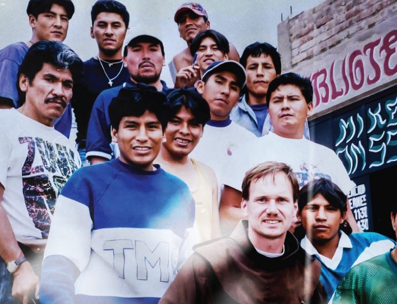 Friar poses with people