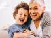 grandmother and grandson laughing together.