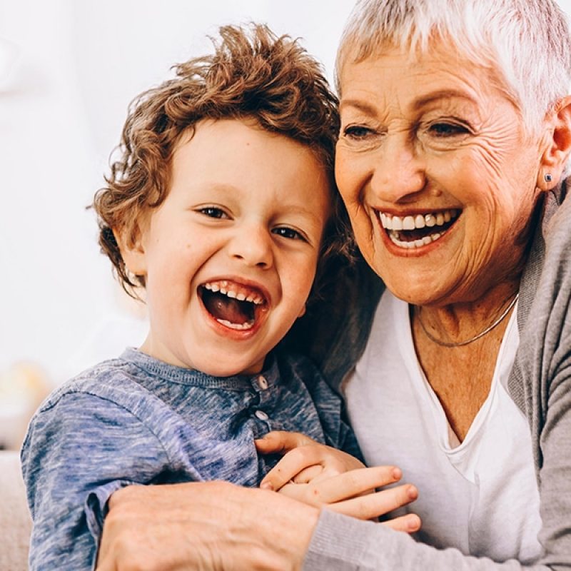 grandmother and grandson laughing together.