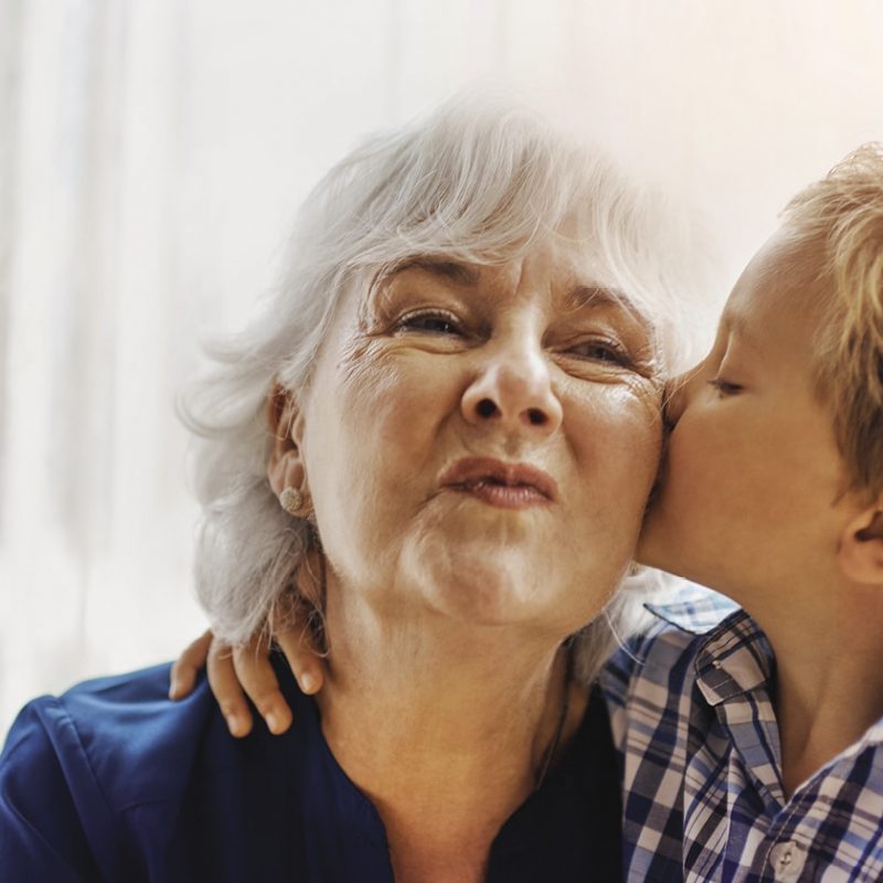 Grandson kissing his grandmother