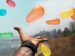 open hand with flying balloons