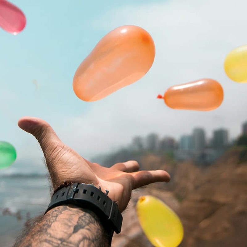 open hand with flying balloons