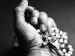 hand holding a rosary with a cross.