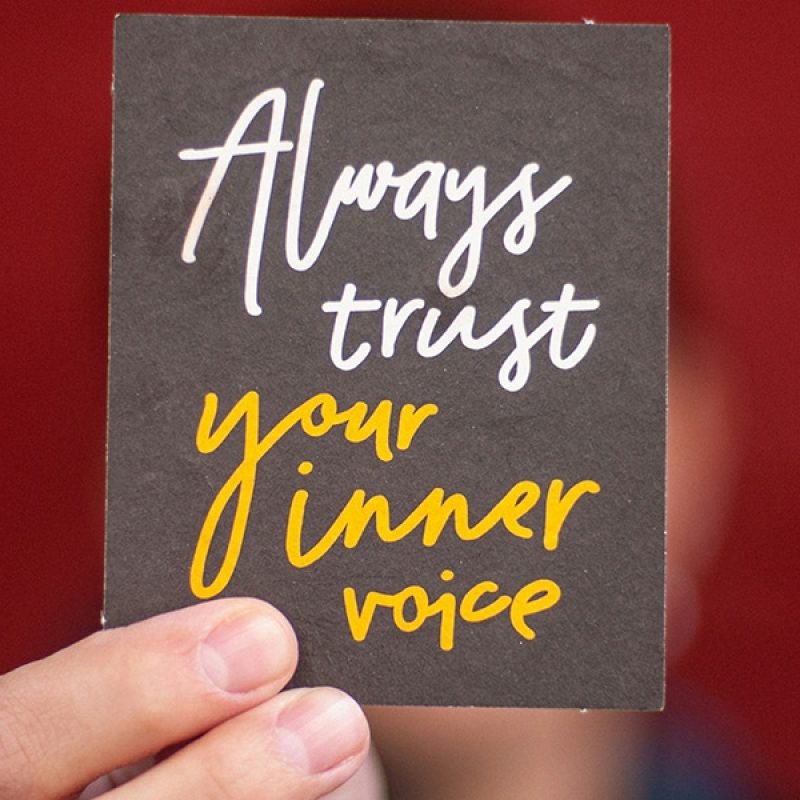 hand holding a sign with the words "always trust your inner voice"